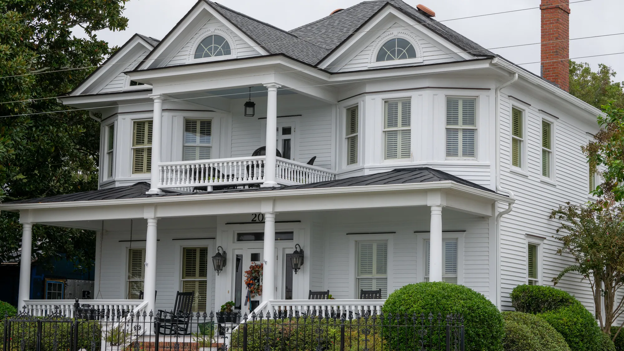 White horizontal siding on a two-story home with porches